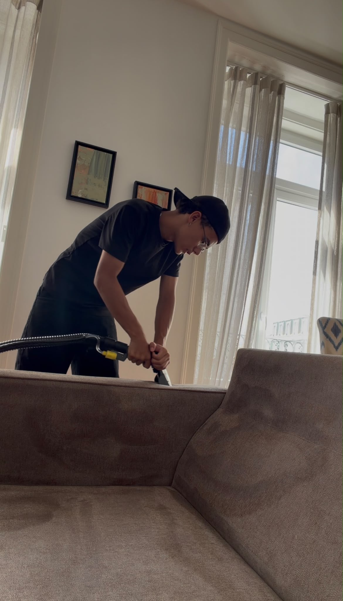 Técnico da W Clean a fazer lavagem profunda de um sofá de tecido em casa de cliente